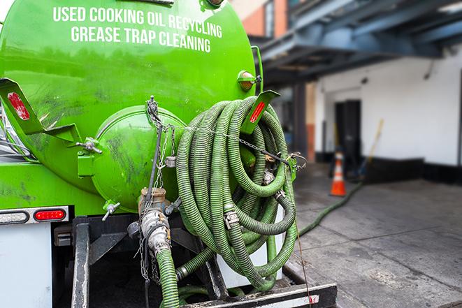 a professional technician pumping a restaurant's grease trap in Beverly